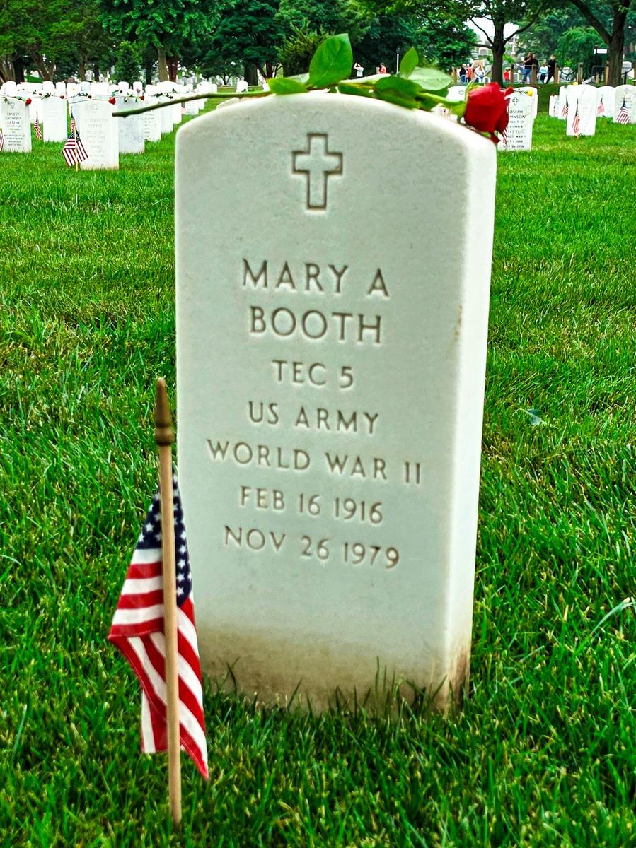 Headstone of Mary A. Booth, TEC 5, US Army, World War II, with a rose laid across the top